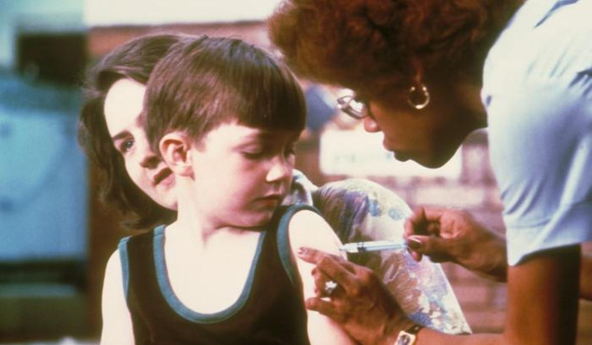 Nurse giving a childhood immunization in a clinic setting